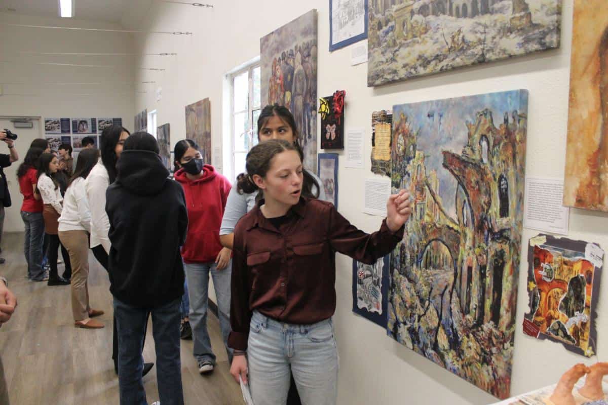 Giorgia explains an art piece from this time, with darker colors and a broken arch, though there are still signs of hope.